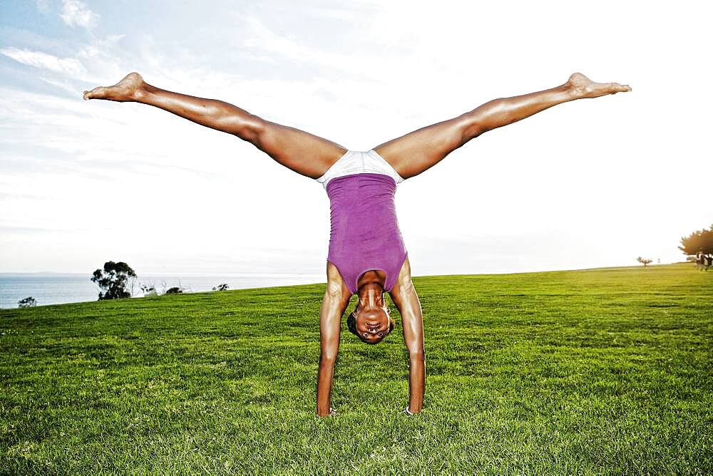 African American woman practicing yoga in park