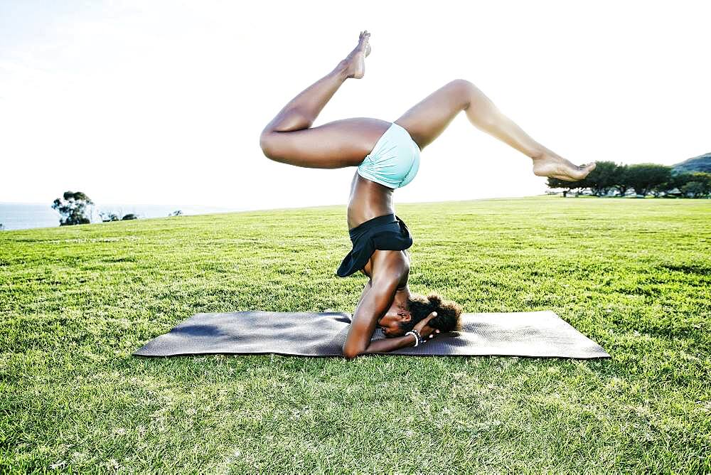 African American woman practicing yoga in park