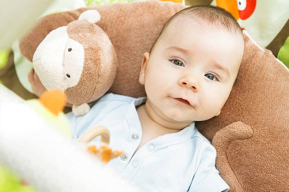 Mixed race baby laying on pillow