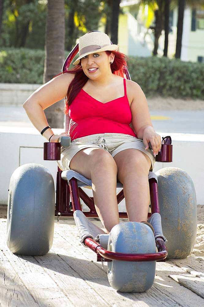 Paraplegic woman in wheelchair on walkway