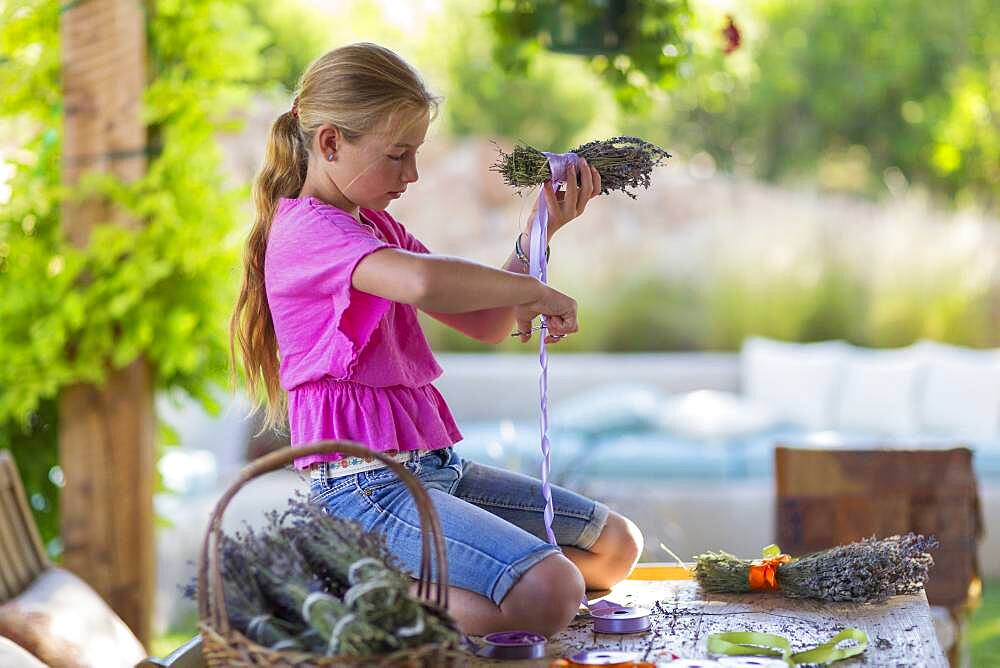 Caucasian girl wrapping dried flower bundle