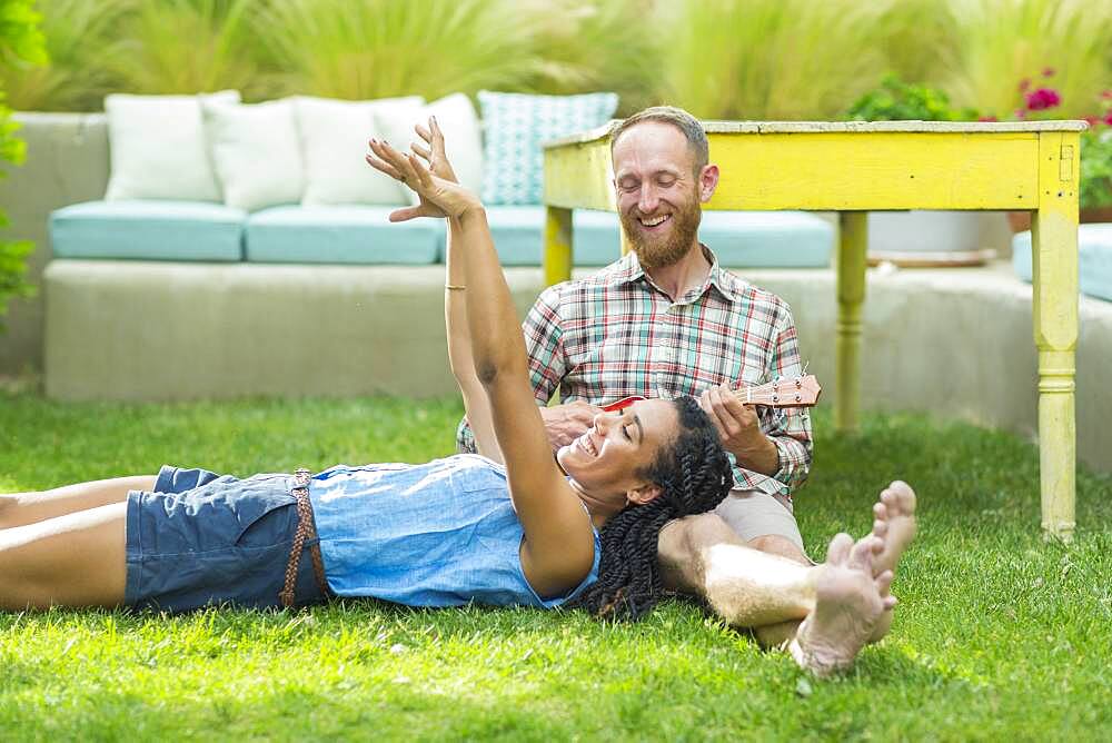 Couple relaxing in backyard