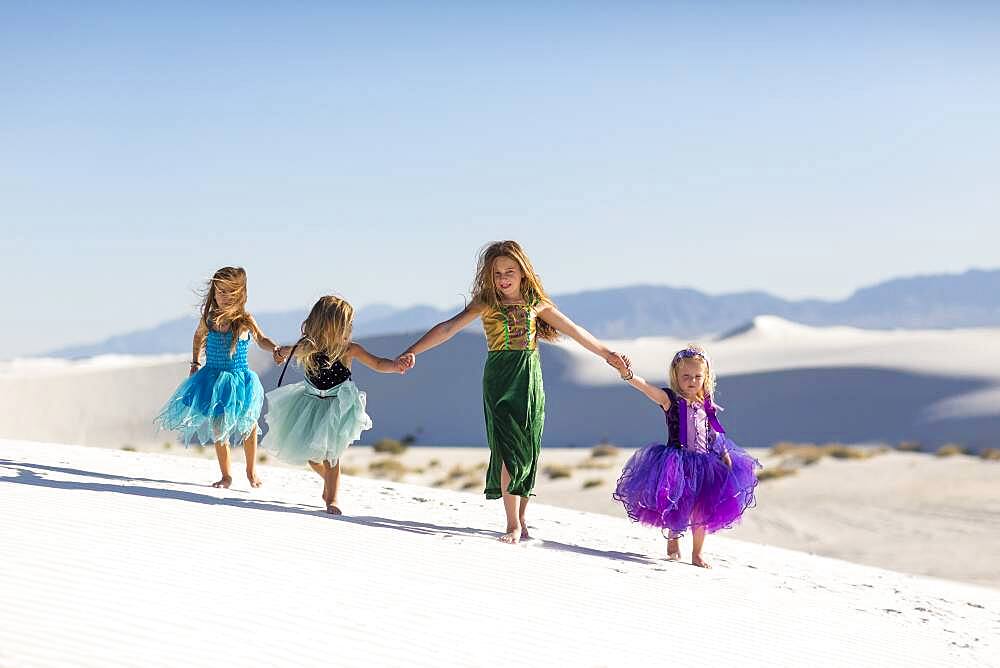 Girls walking on desert sand dunes