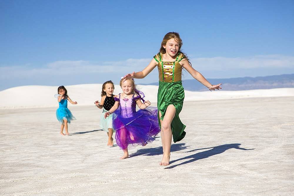 Girls walking on desert sand dunes