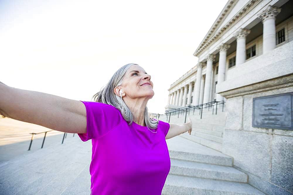 Caucasian woman standing outside courthouse