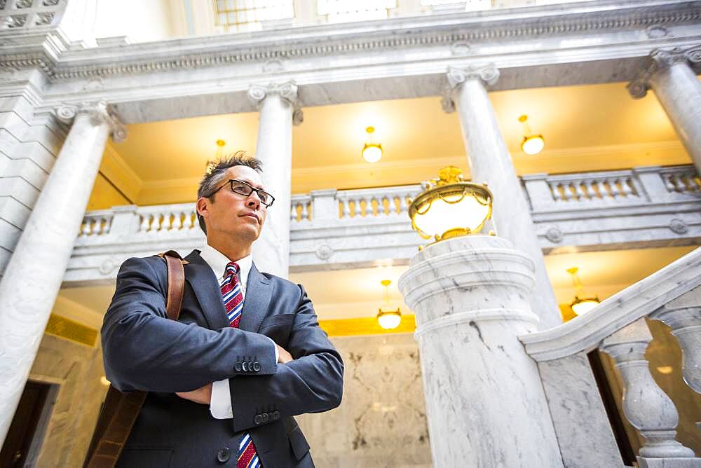 Mixed race businessman standing in courthouse