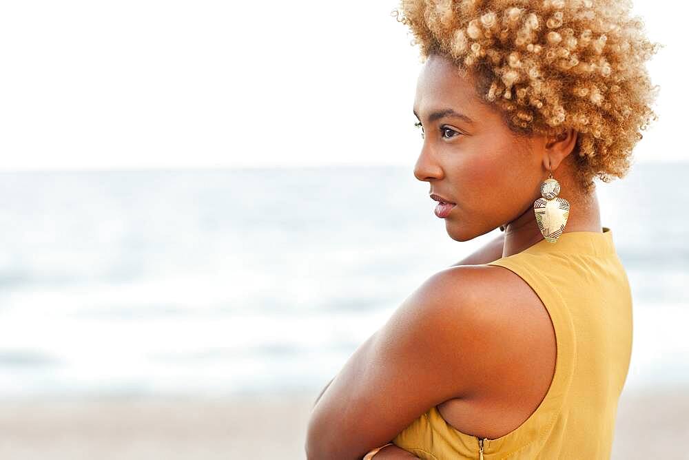 Profile of pensive Black woman at beach