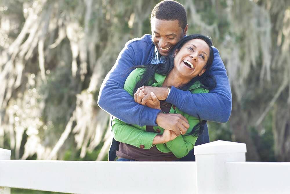 Couple hugging near fence