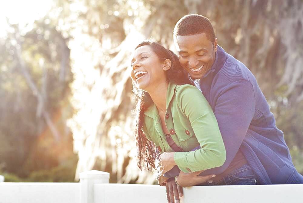 Couple hugging on fence