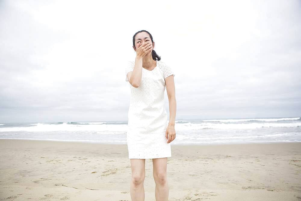 Woman laughing on beach