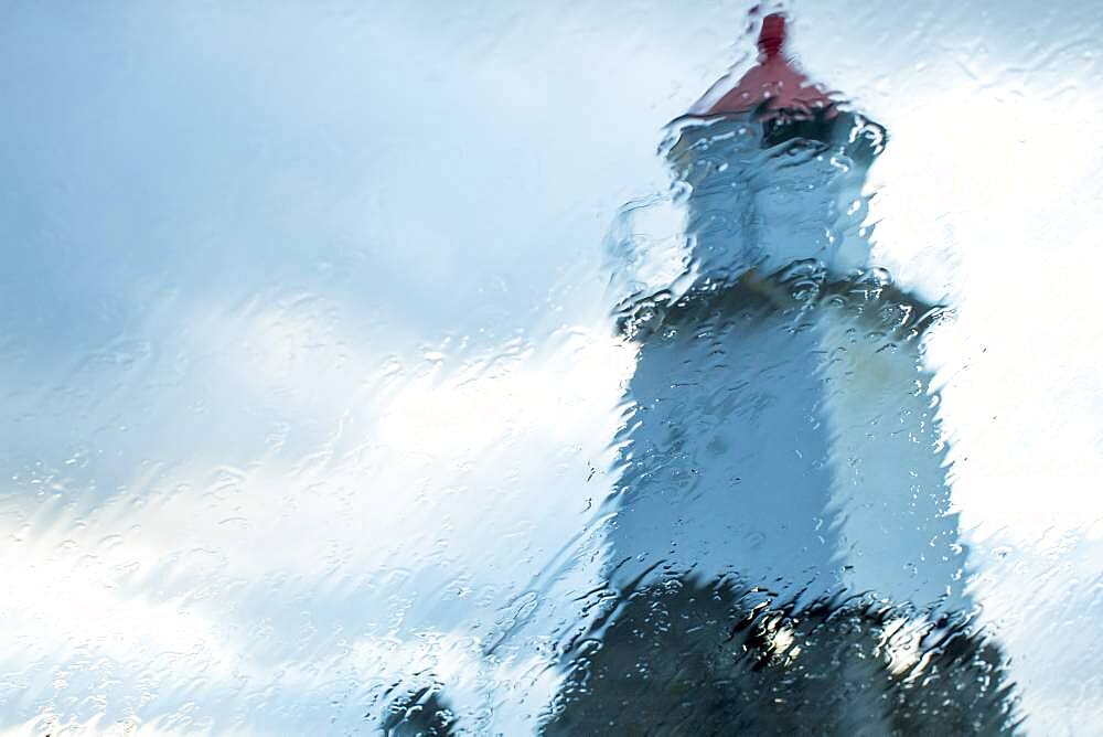 Laukvika Lighthouse viewed through rainy window, Laukvika, Lofoten Islands, Norway