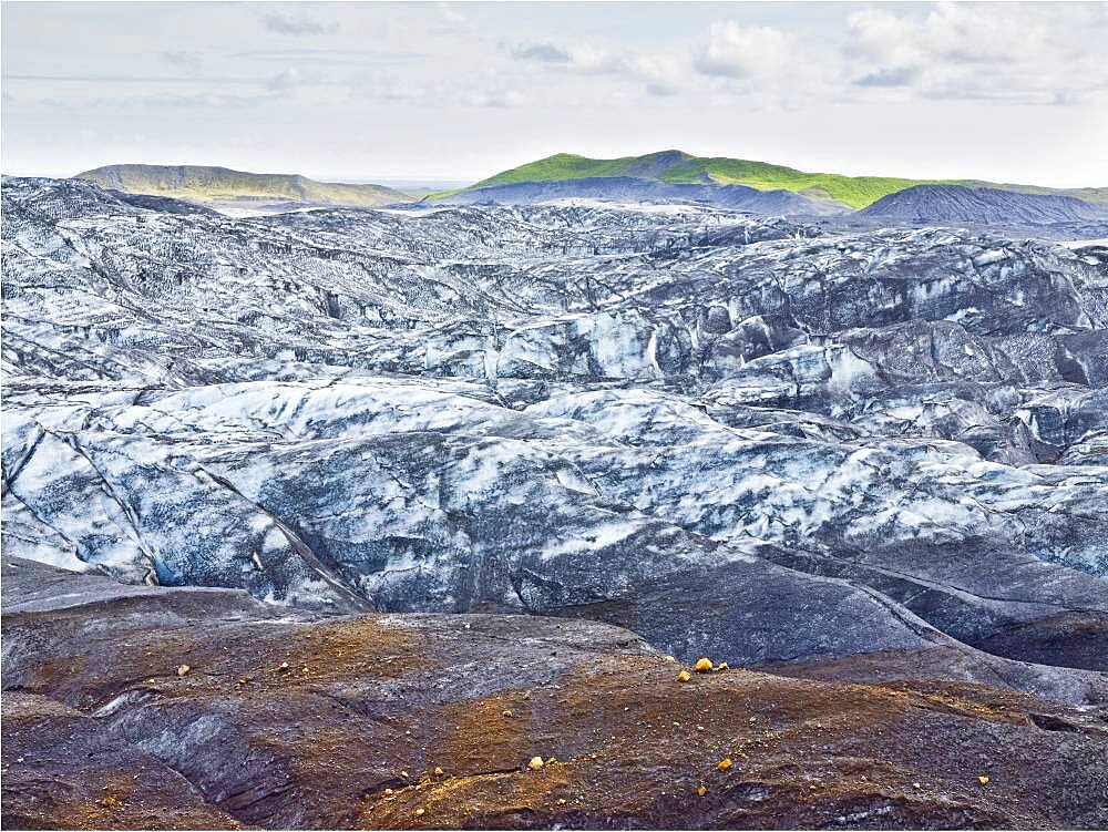 Snow on remote rock formations, Myrdalsjokull Glacier, South Iceland, Iceland