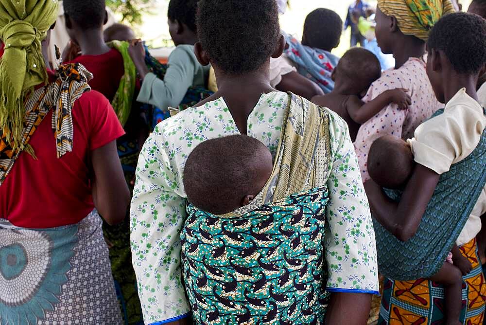 Mothers carrying children and waiting at rural health clinic