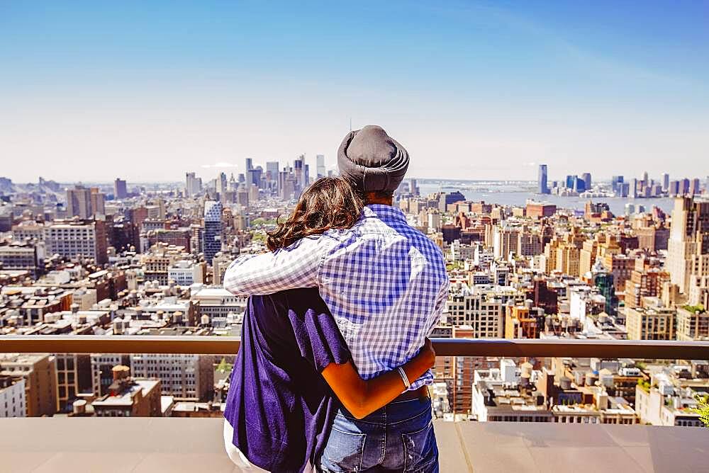 Indian couple admiring New York cityscape, New York, United States