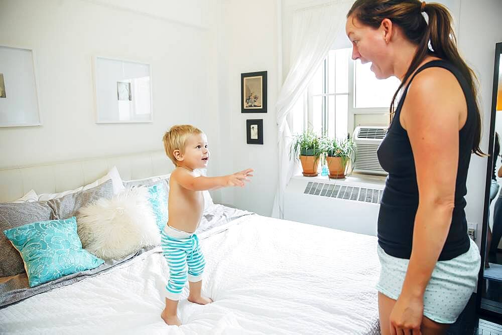 Mother and son talking in bedroom