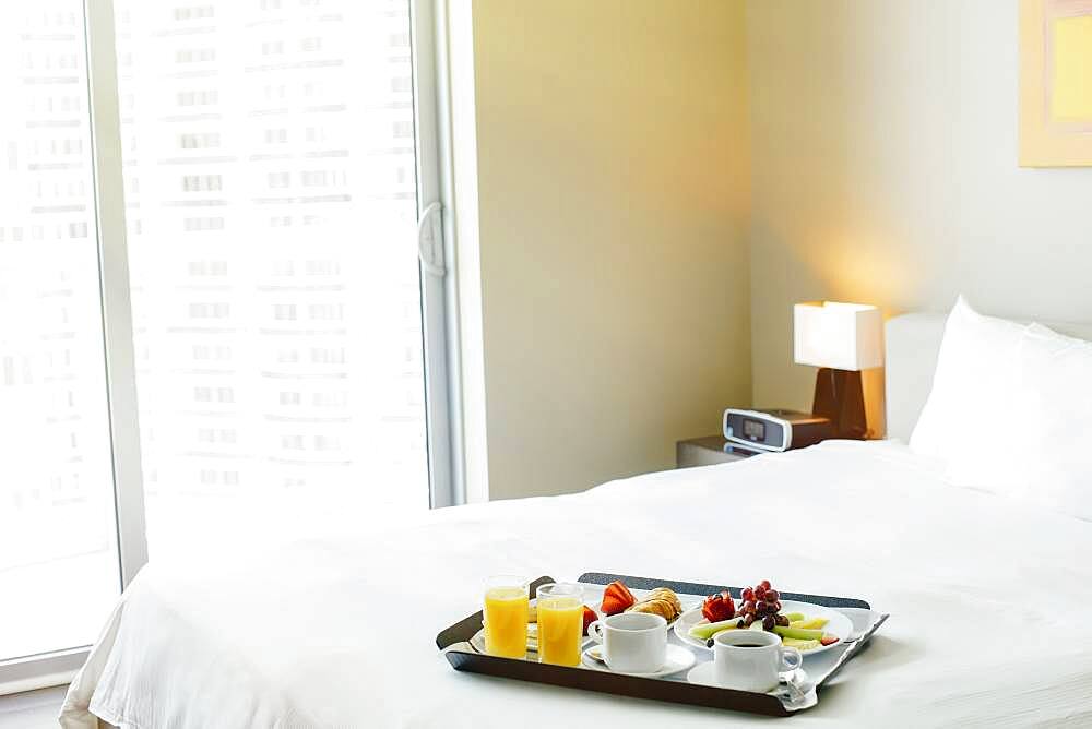 Breakfast tray on hotel bed