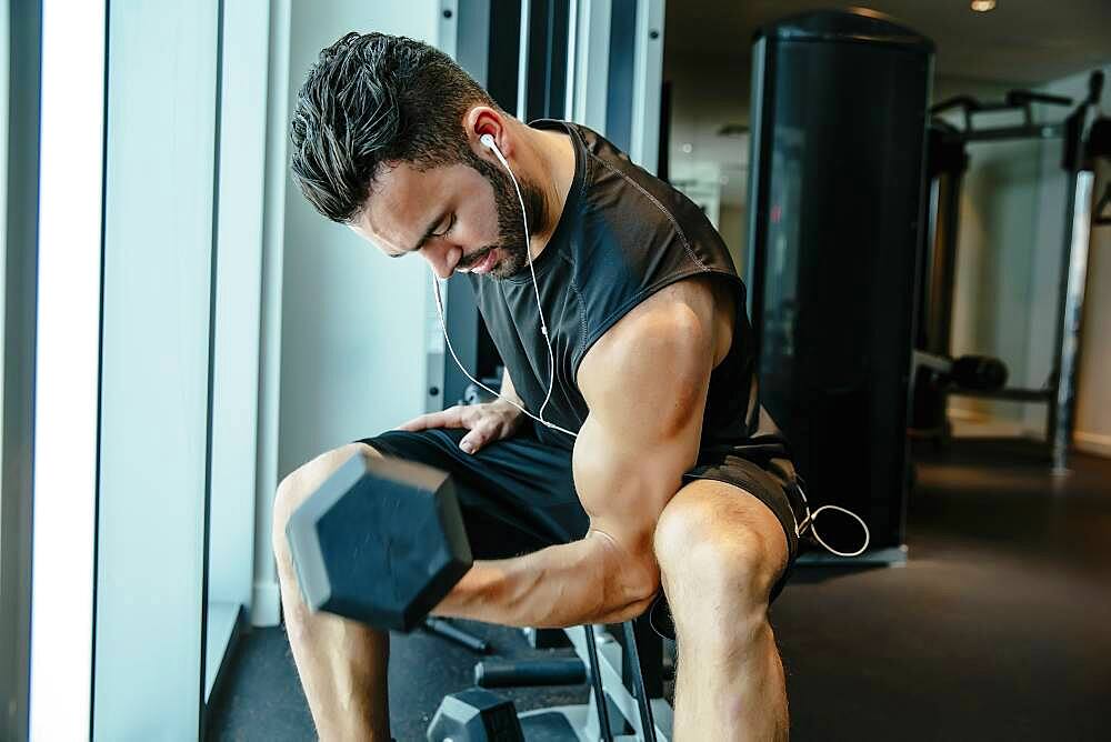 Man lifting weights in gymnasium