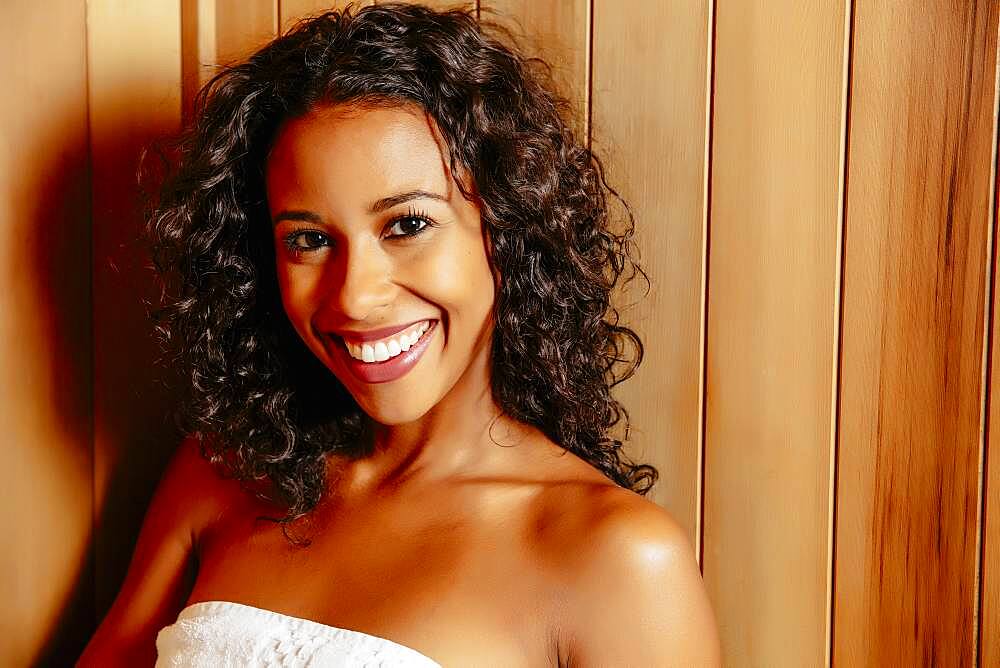 Smiling woman relaxing in sauna