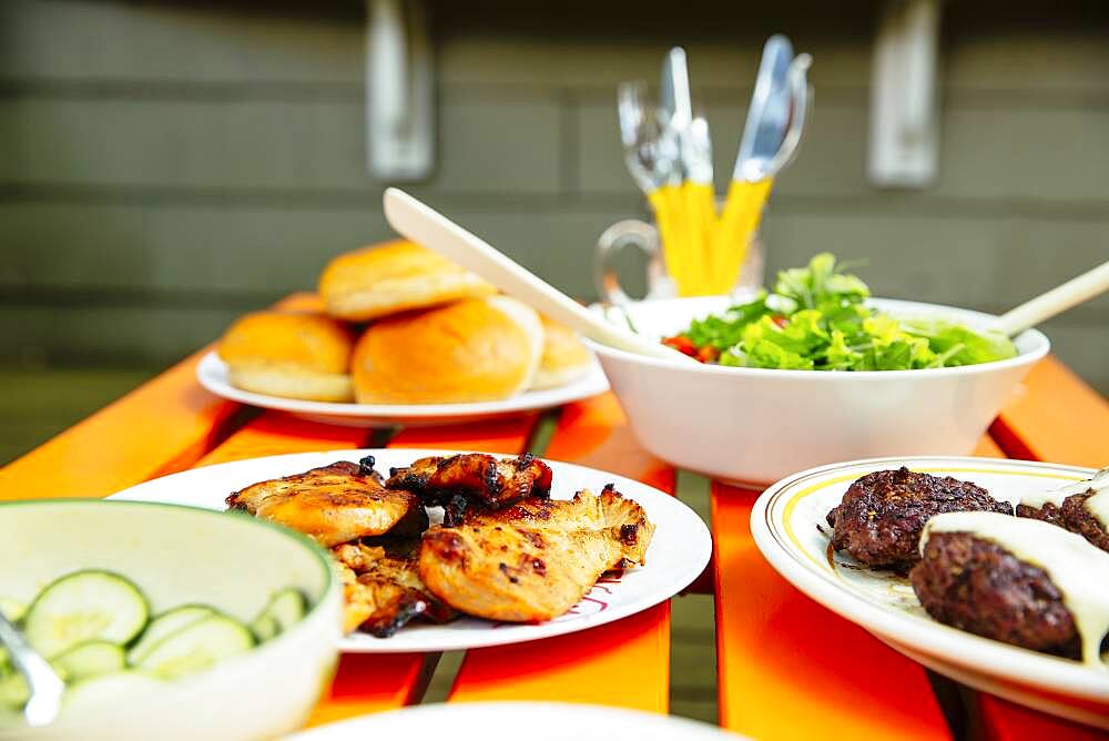 Close up of salad, meat, cucumbers and salad on table