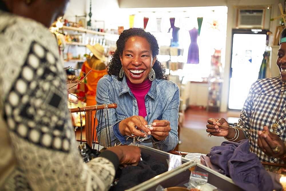 Women admiring jewelry in store