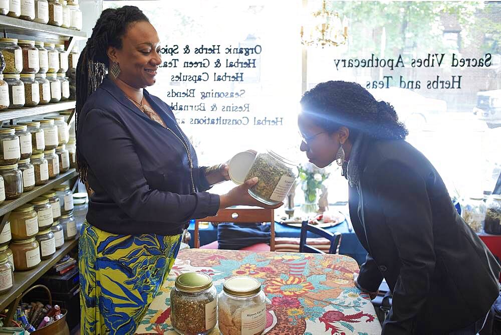 Black woman smelling tea in tea shop