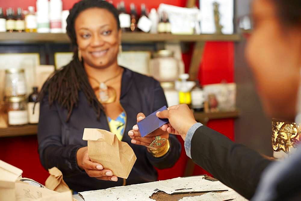 Black woman serving customer in tea shop