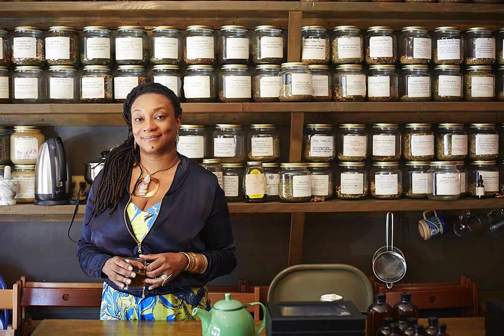 Black woman drinking tea in tea shop