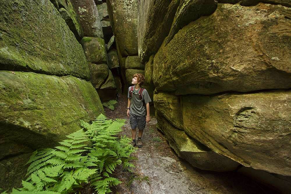 Caucasian teenage boy exploring cave