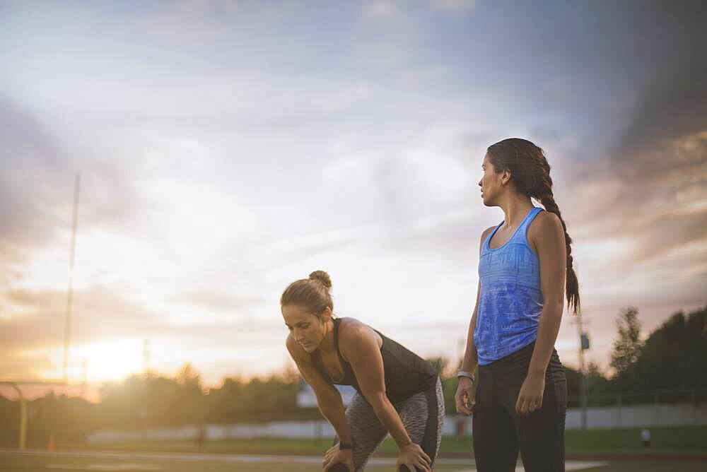 Athletes resting on sports field