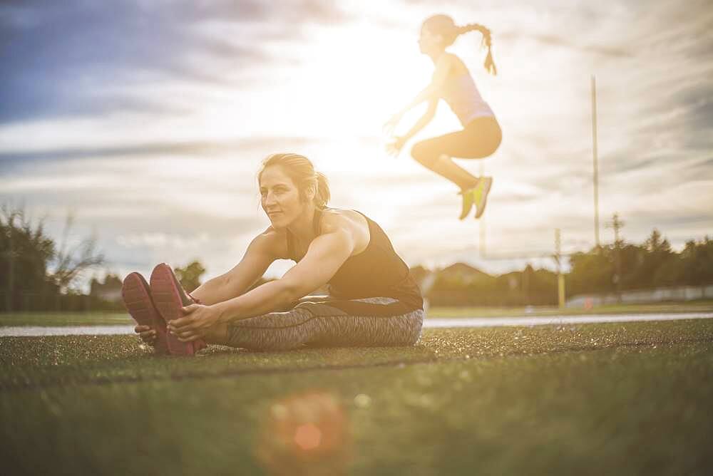 Athletes stretching on sports field