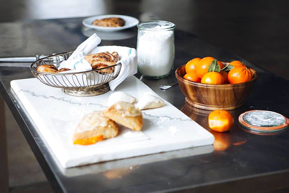 Bread, cheese and fruit on table