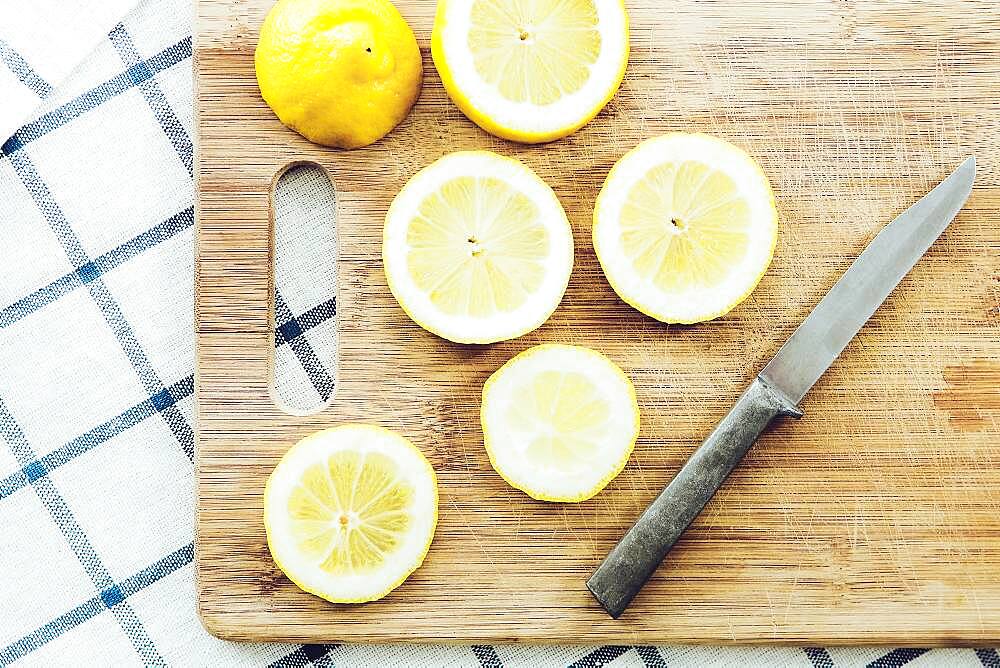 Sliced lemon on wooden cutting board