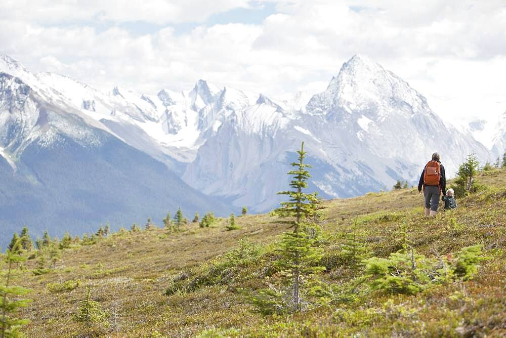 Caucasian mother and son hiking on remote hillside