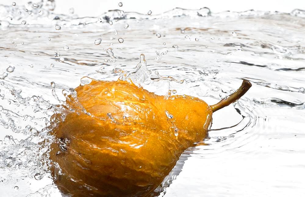 Close up of pear splashing in water