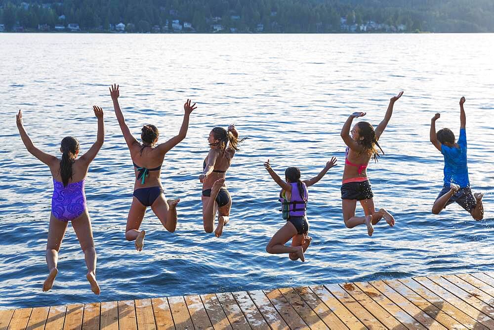 Children jumping into lake