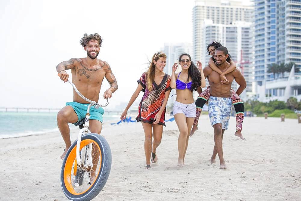 Friends walking on urban beach