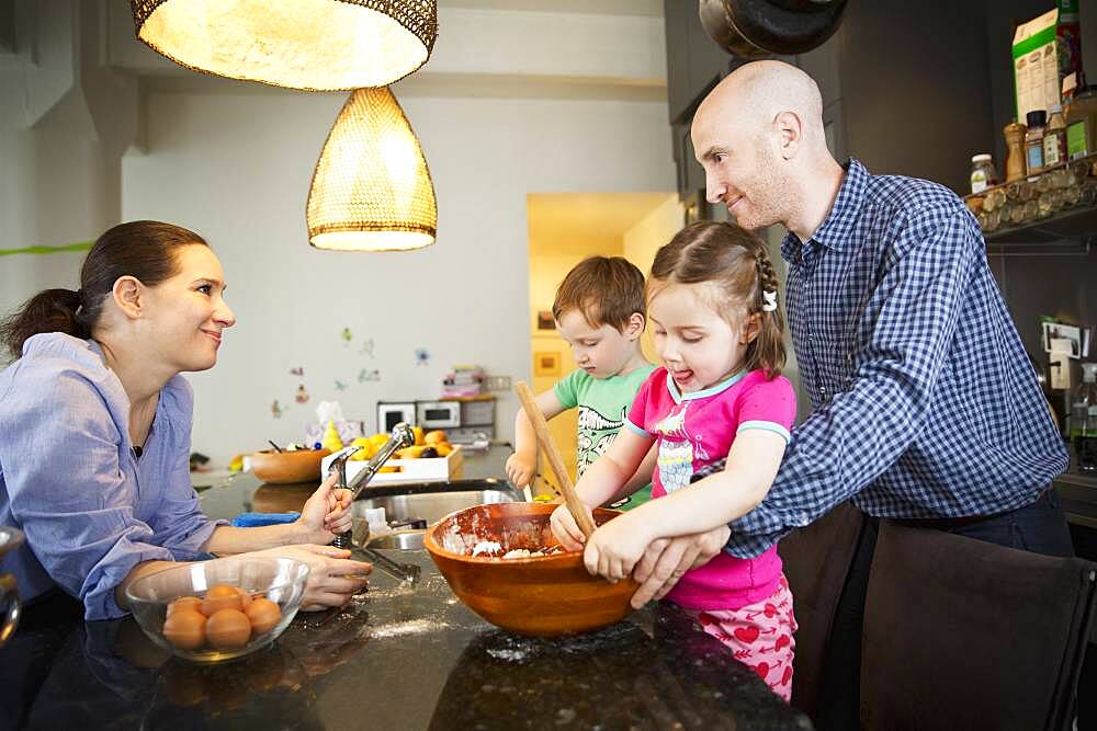 Family cooking in kitchen