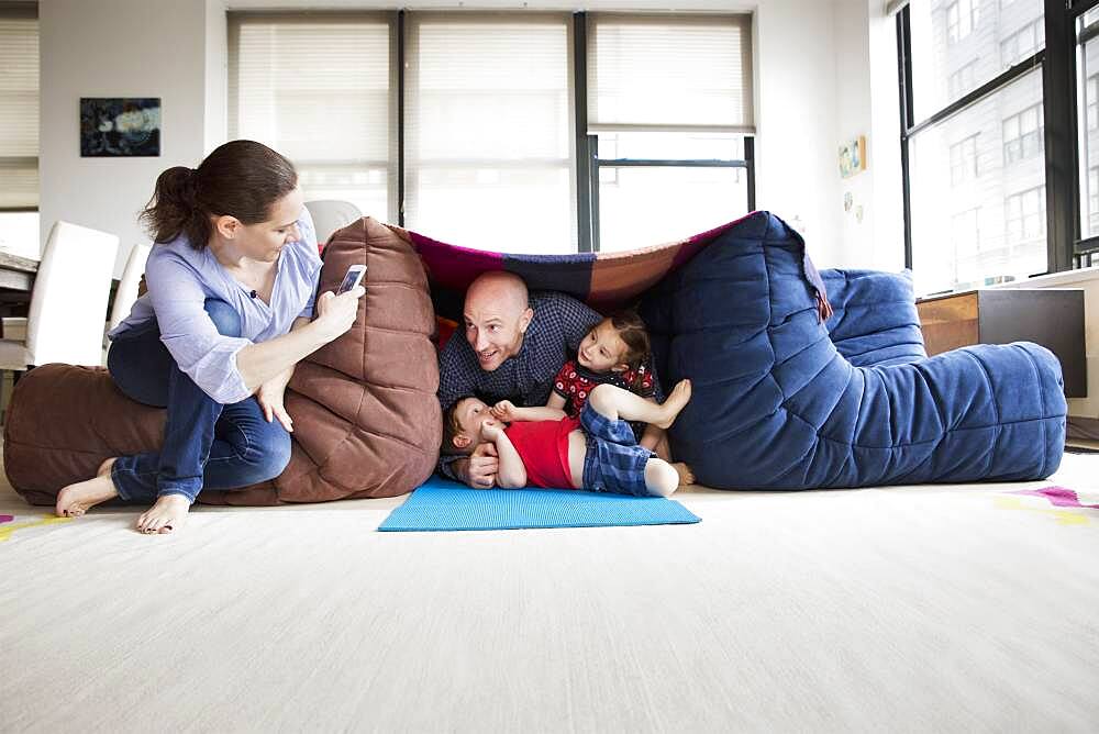 Family playing in blanket fort