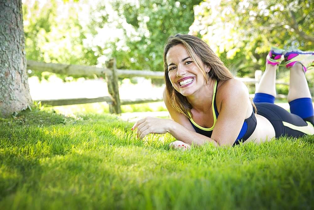 Mixed race woman laying in grass