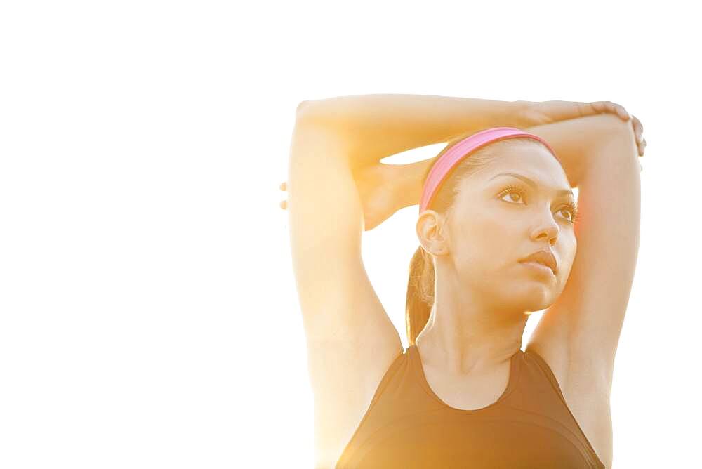 Hispanic woman stretching outdoors