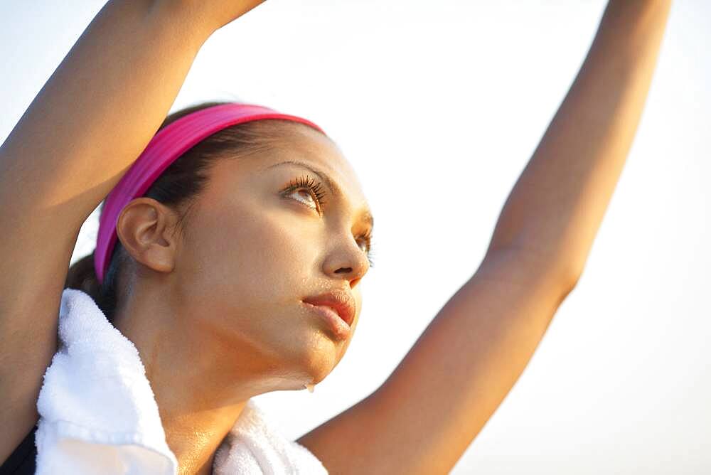 Hispanic woman stretching outdoors