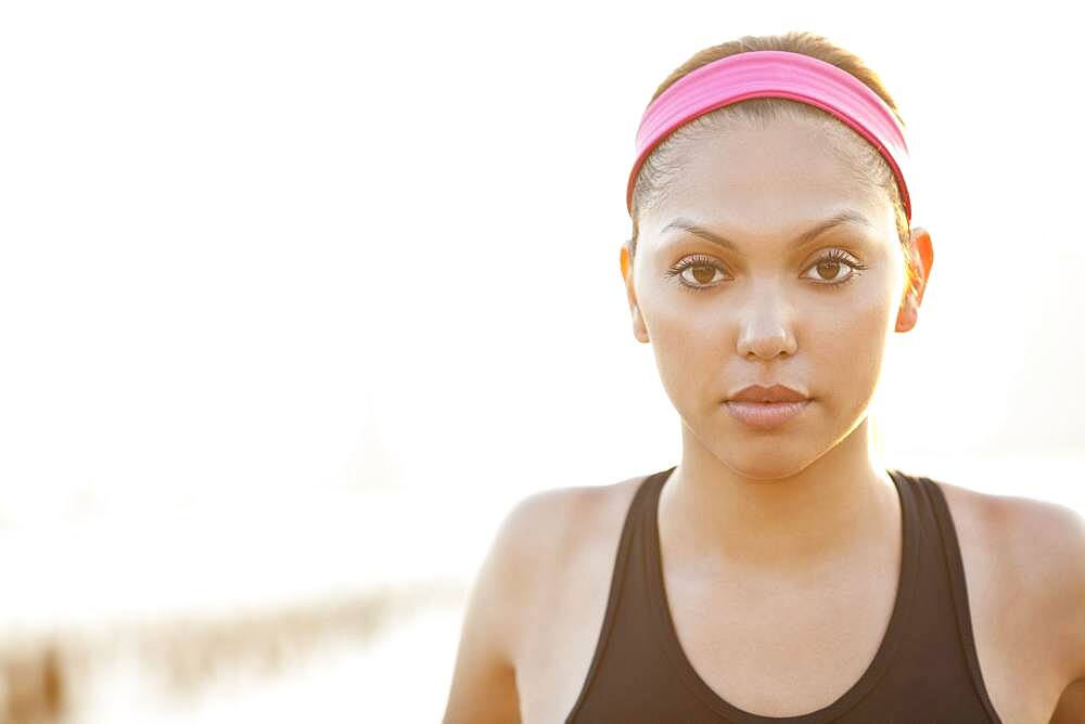 Serious Hispanic woman wearing headband