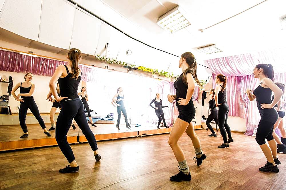 Caucasian dancers practicing in studio