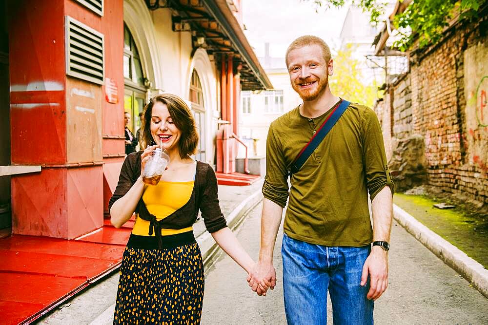 Caucasian couple walking in city street