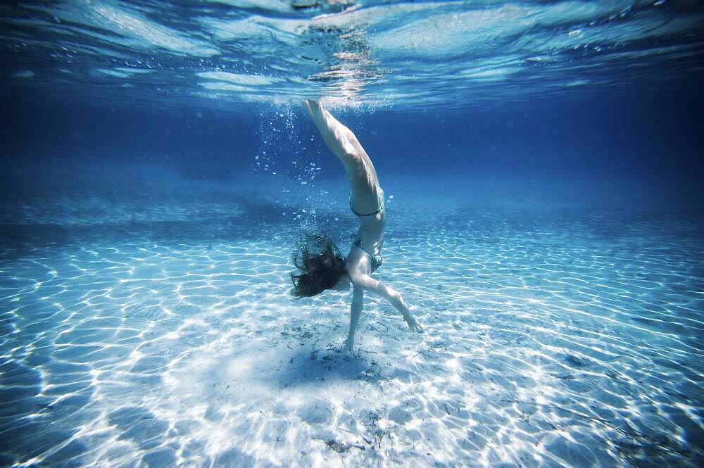 Underwater view of woman swimming in ocean