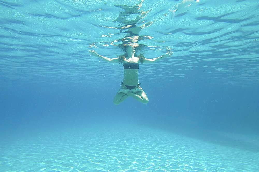 Underwater view of woman swimming in ocean