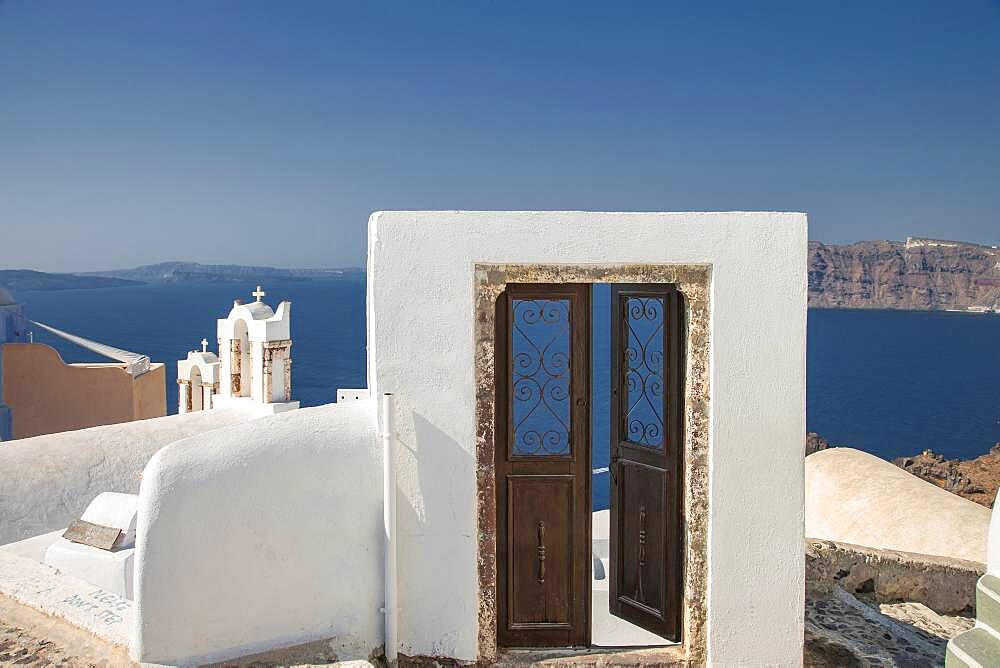 Door on hilltop over seascape