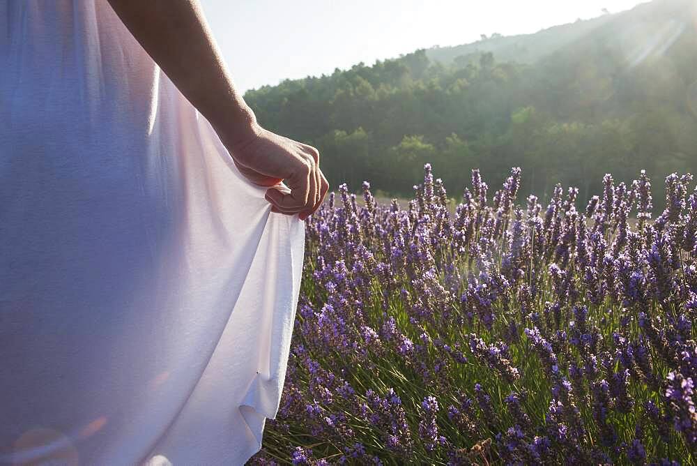 Caucasian woman walking in field of flowers