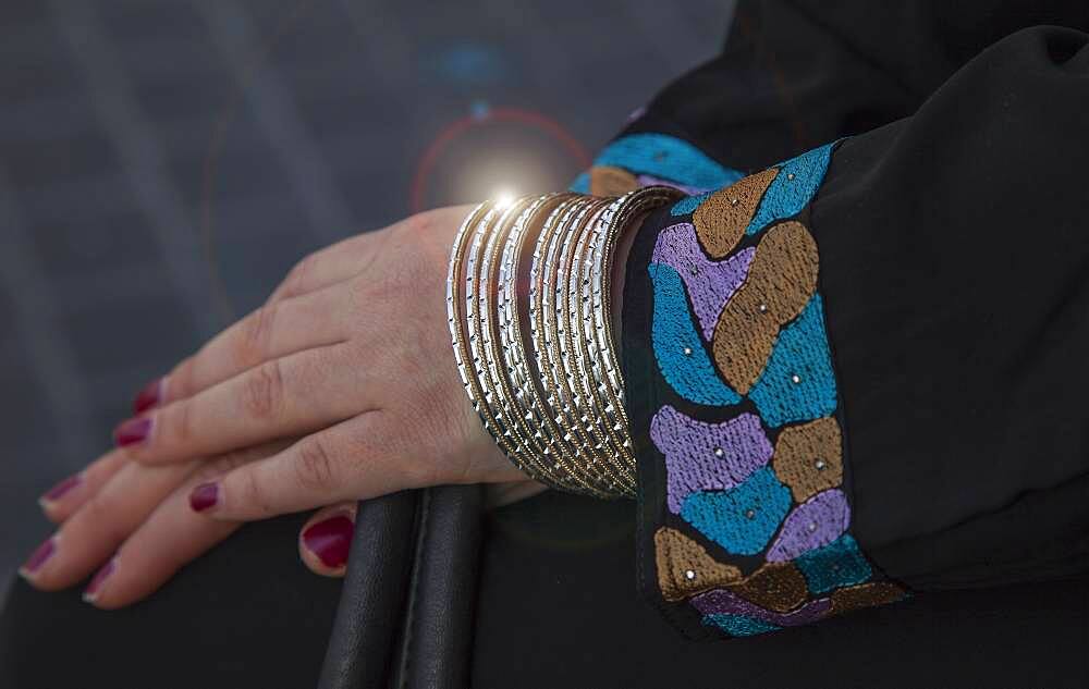 Caucasian woman wearing gold bracelets