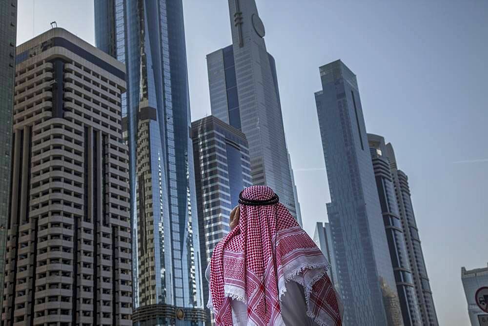 Pakistani man admiring highrise buildings in Dubai cityscape, Dubai Emirate, United Arab Emirates